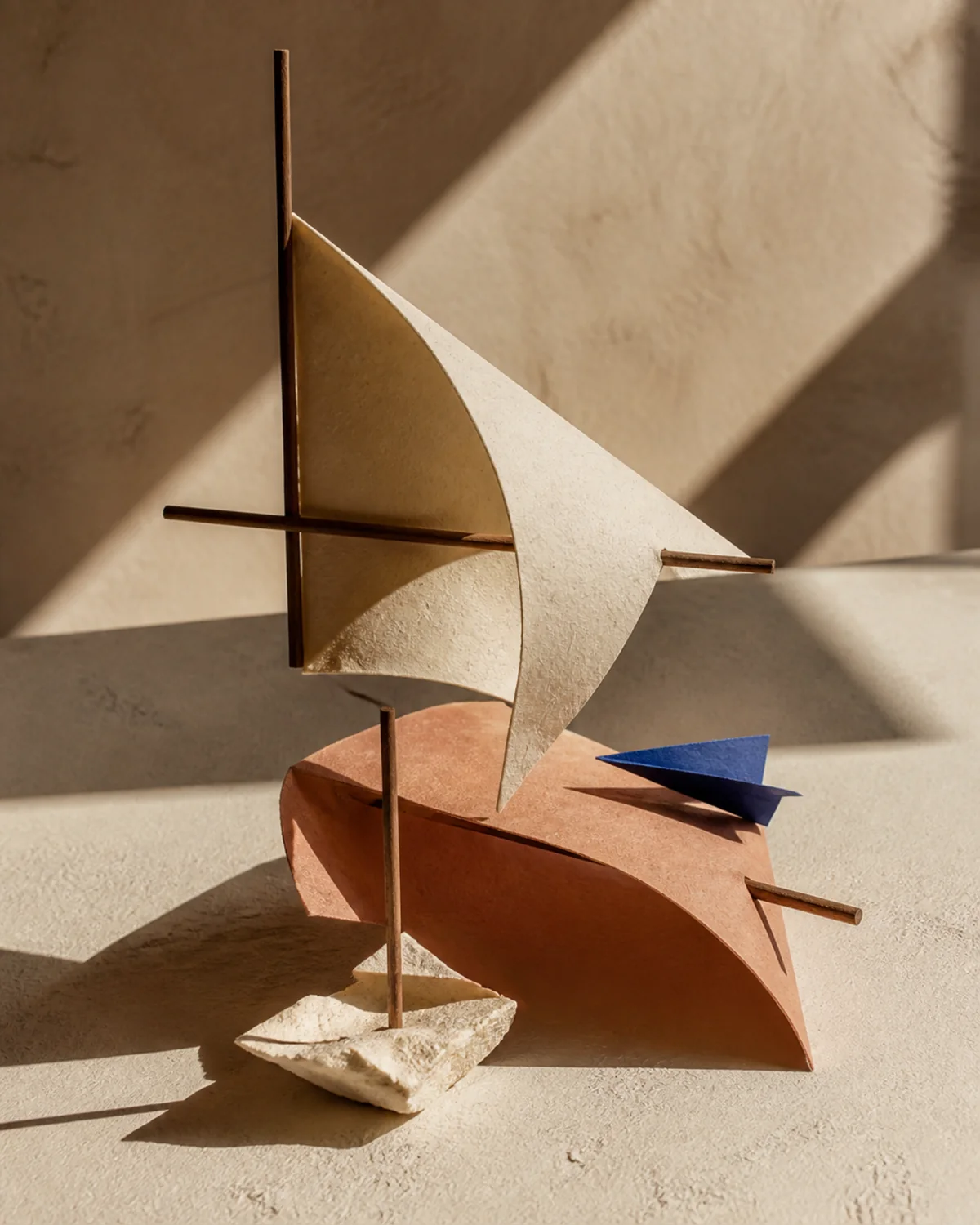 A folded paper and walnut architectural sculpture